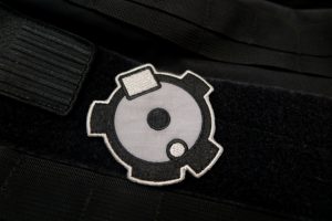 Picture of Desert Eagle Boltface patch on a black velcro backing with MOLLE webbing above and below